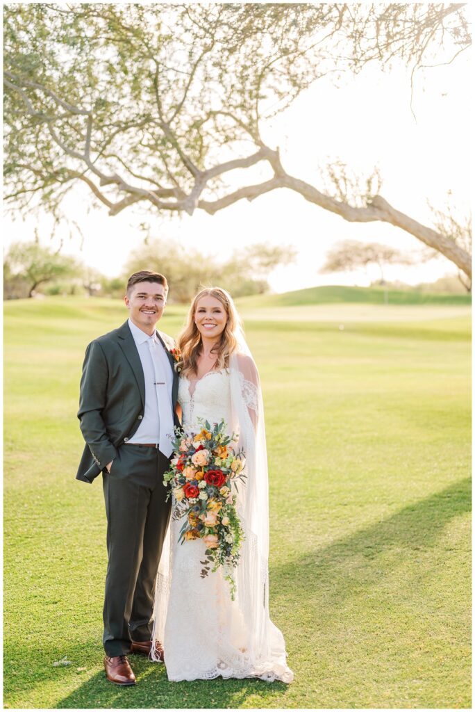 wedding couple portraits next to a large tree on the golf course at Gold Canyon, Arizona venue