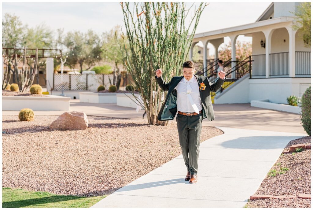 groom dancing down the aisle towards the altar outside at the Gold Canyon Golf Resort