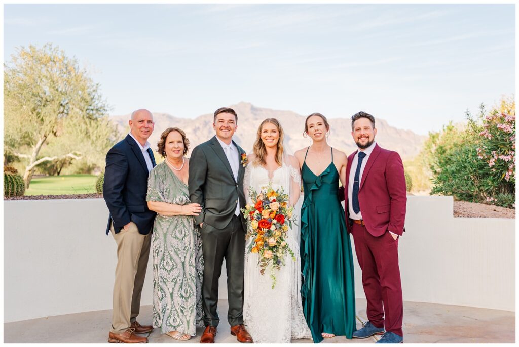 wedding couple posing with family overlooking the wedding venue in Gold Canyon, Arizona