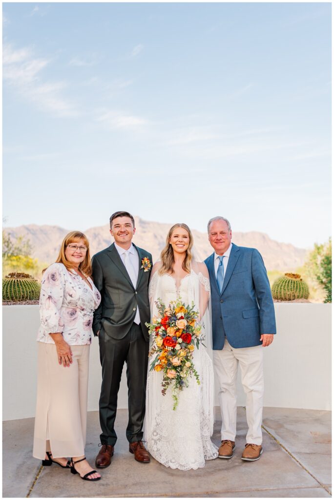 bride and groom posing with family overlooking the wedding venue in Gold Canyon, Arizona