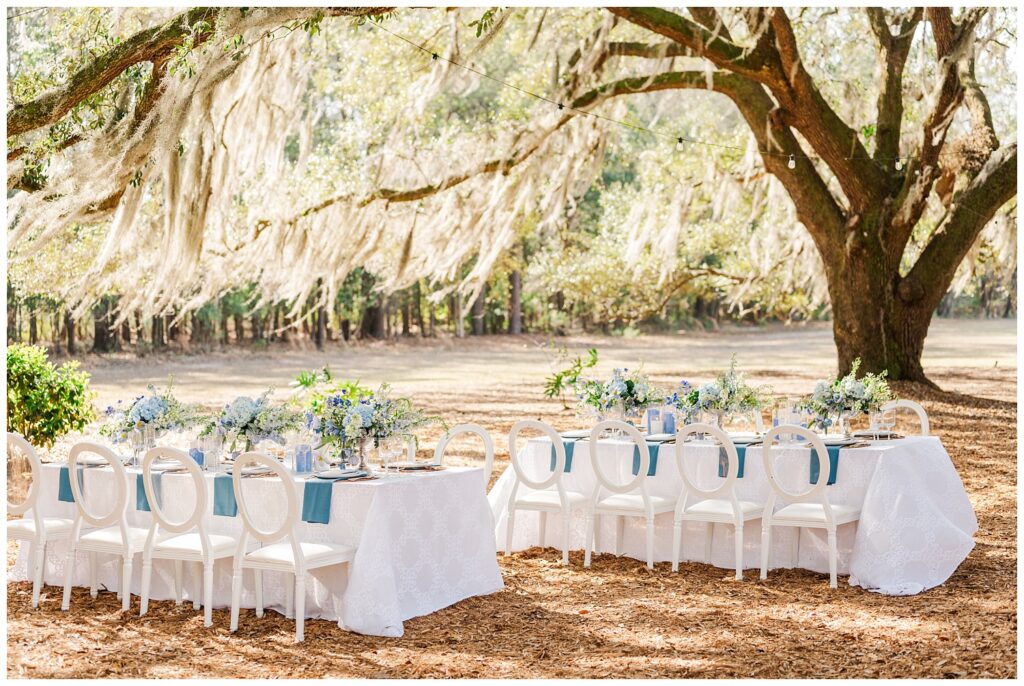 decorated reception tables outside under a live oak tree in Bluffton, SC