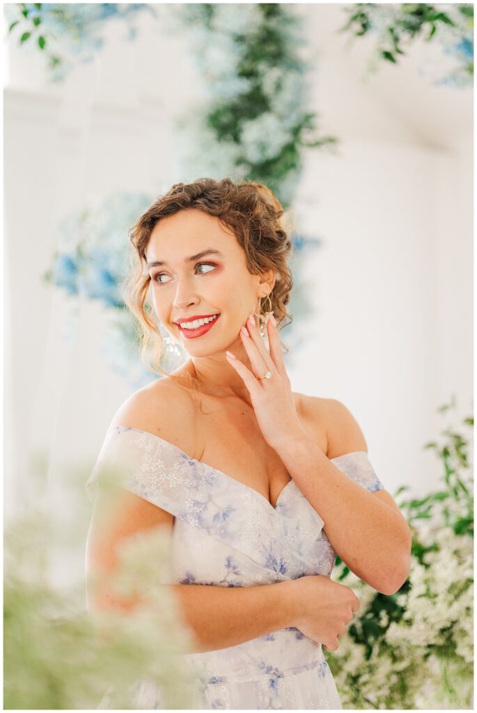 bride looking away while showing off her engagement ring at Hewitt Oaks wedding venue