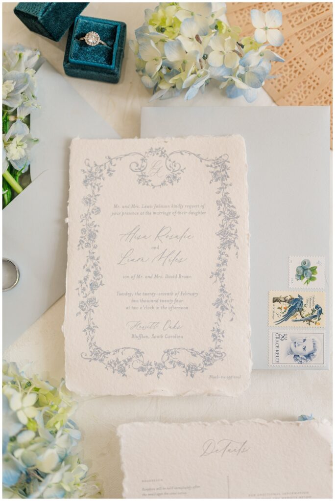 blue and white wedding invitation surrounded by small hydrangeas at SC styled shoot