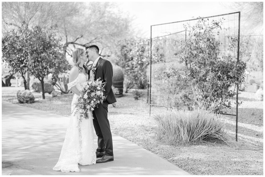 wedding couple kiss on the sidewalk after having their first look