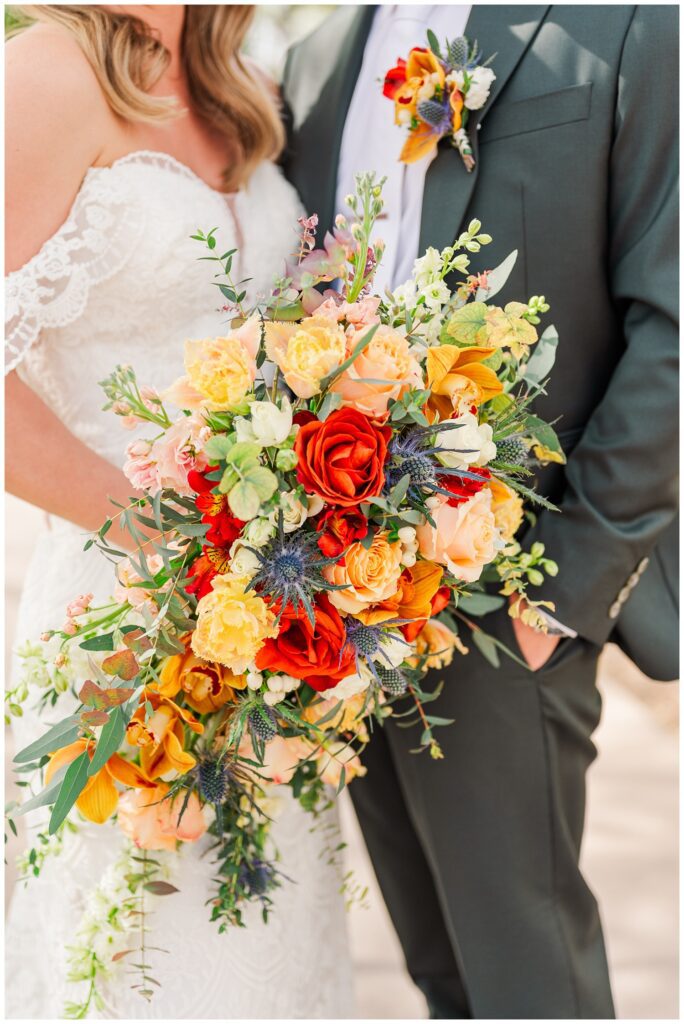 close up detail of the bride holding her bouquet with the groom before the ceremony