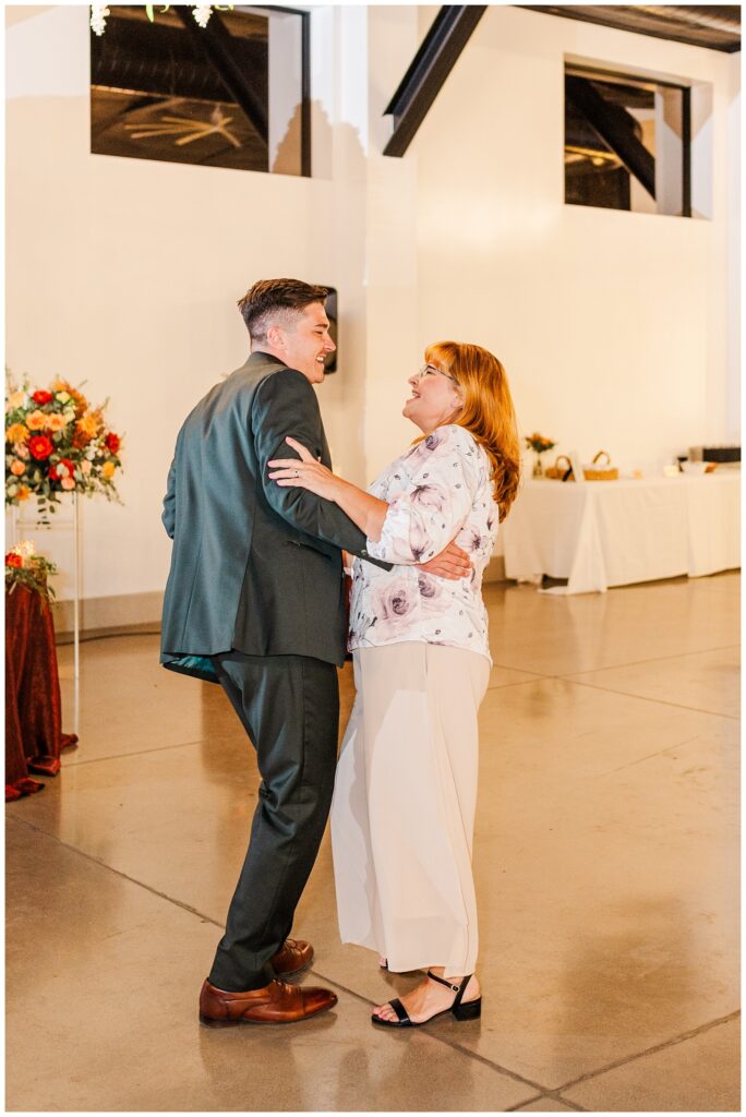 groom dancing with his mom inside at the reception at Gold Canyon resort venue