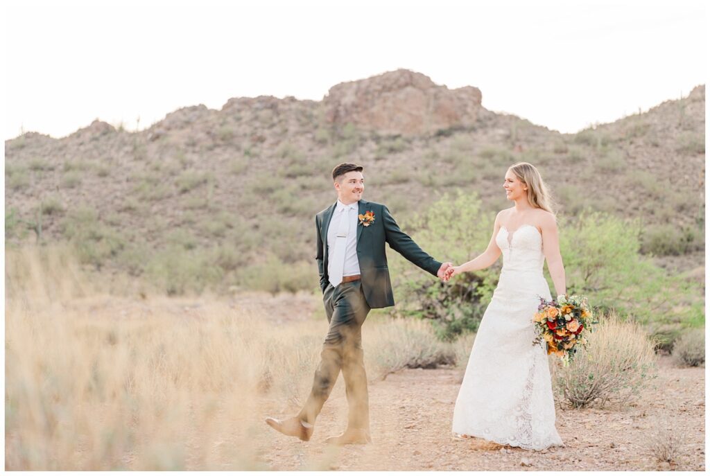 bride and groom posing in the desert at Gold Canyon Golf Resort wedding venue
