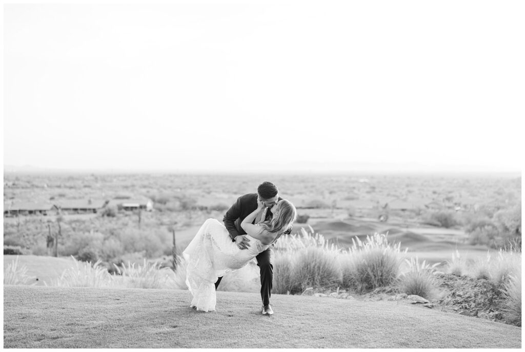 groom dipping the bride on the golf course at Arizona wedding