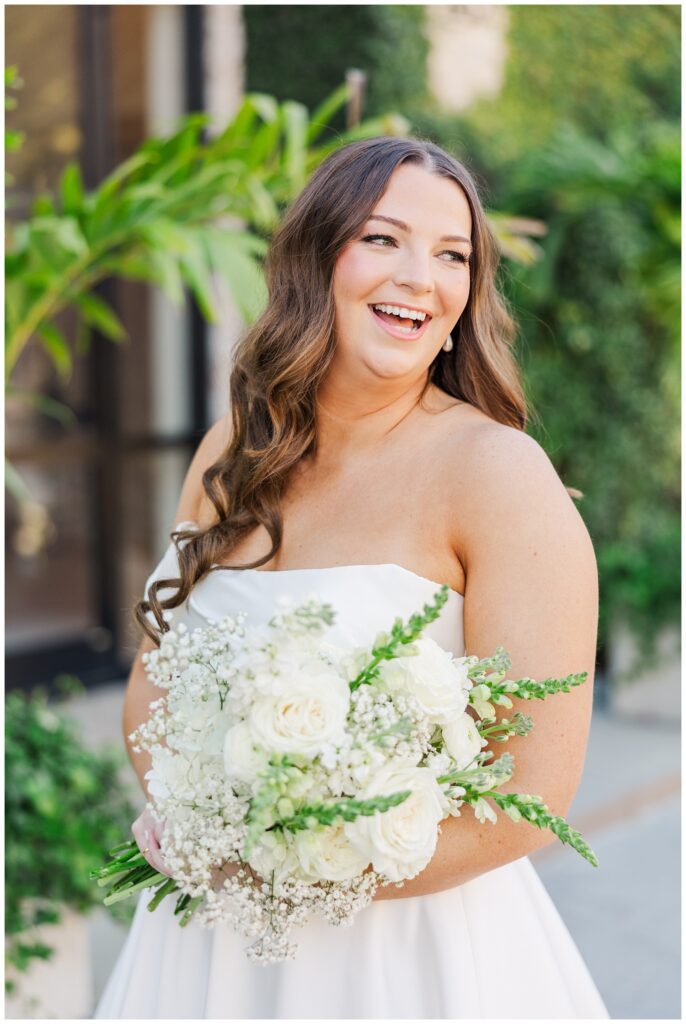 bride smiling and holding her bouquet at the Wilmington wedding venue 