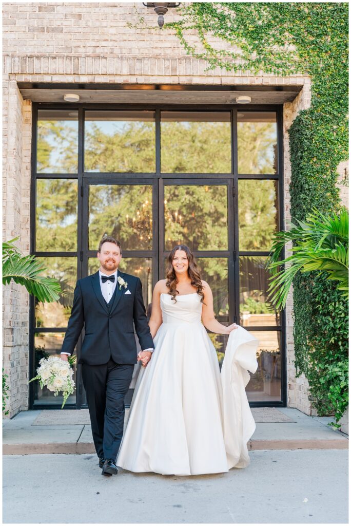Wilmington wedding photographer taking portraits of the bride and groom walking away from the venue