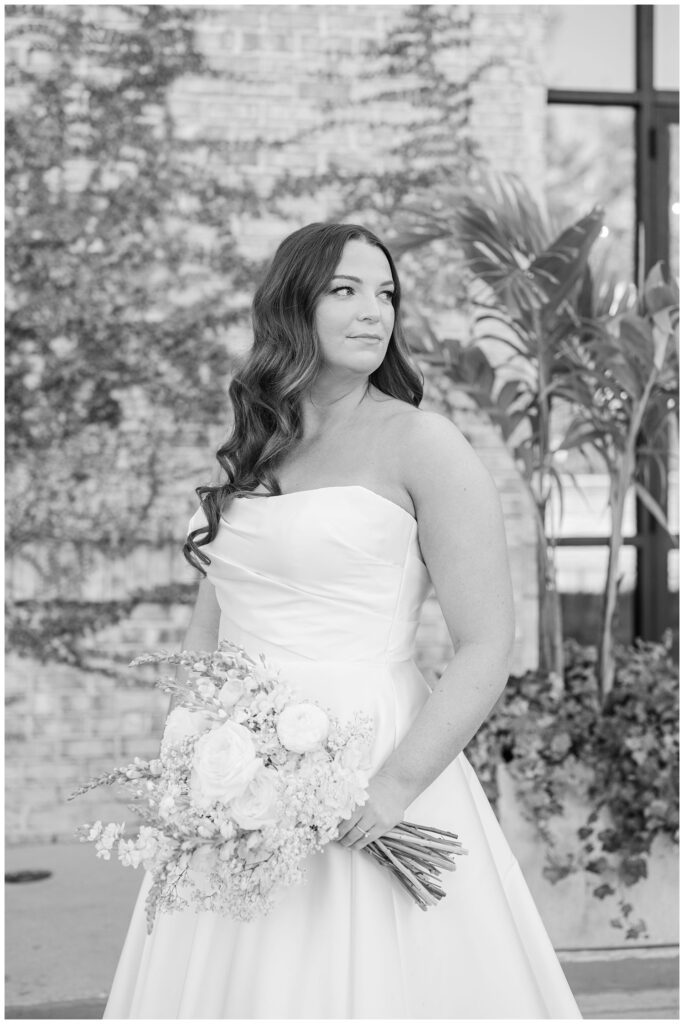 bride posing with her bouquet and looking off into the distance at Wilmington wedding