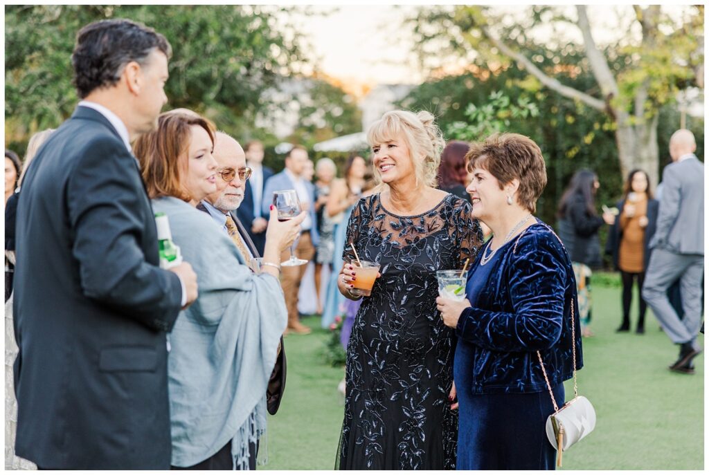 guests mingling and talking during cocktail hour outside at Wrightsville Manor
