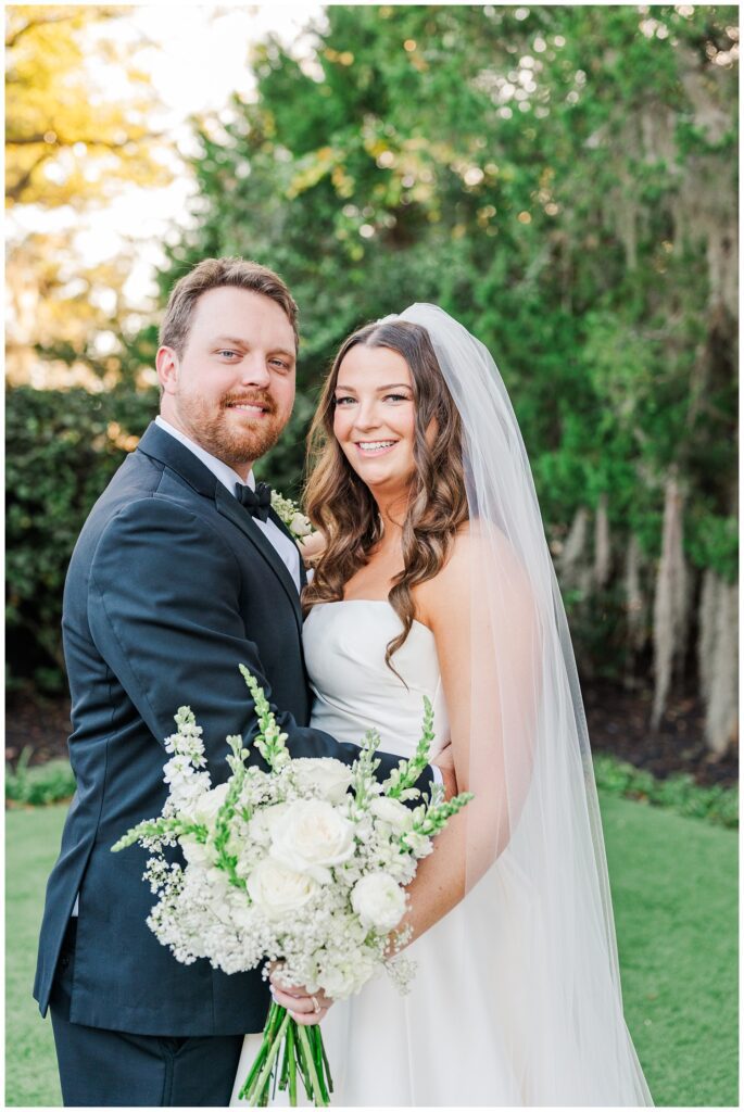 groom holding the bride around the waist outside during golden hour in Wilmington