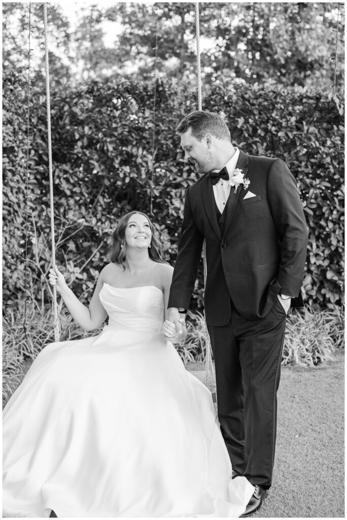 bride swinging while the groom holds her hand and smiles at her during golden hour