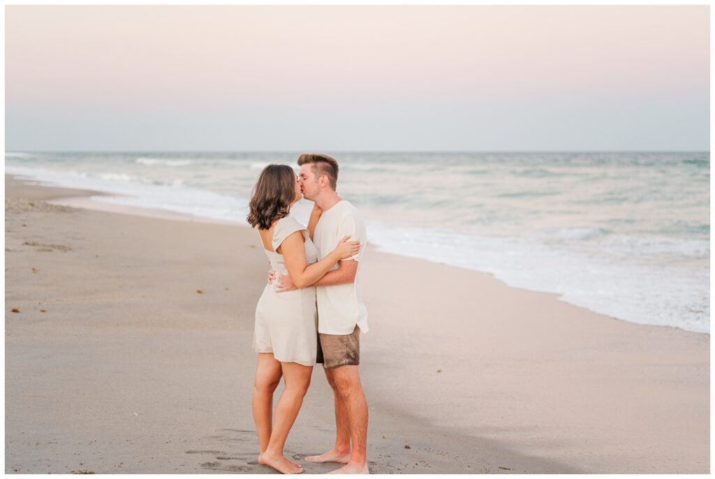 couple kissing on the sand at Wrightsville Beach engagement session