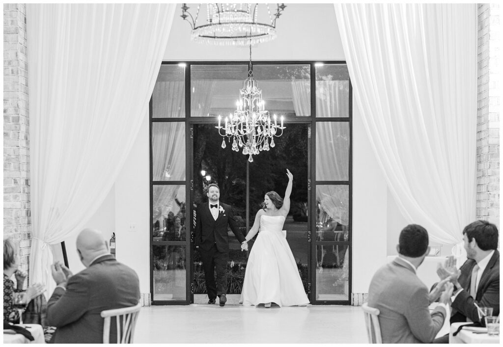 wedding couple making their entrance into the reception at Wrightsville Manor venue