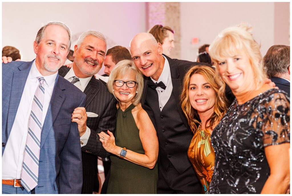 wedding guests posing for pictures during reception at Wrightsville Manor