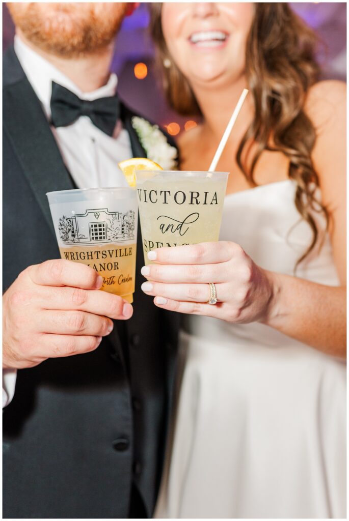 bride and groom holding their personalized cups during the reception