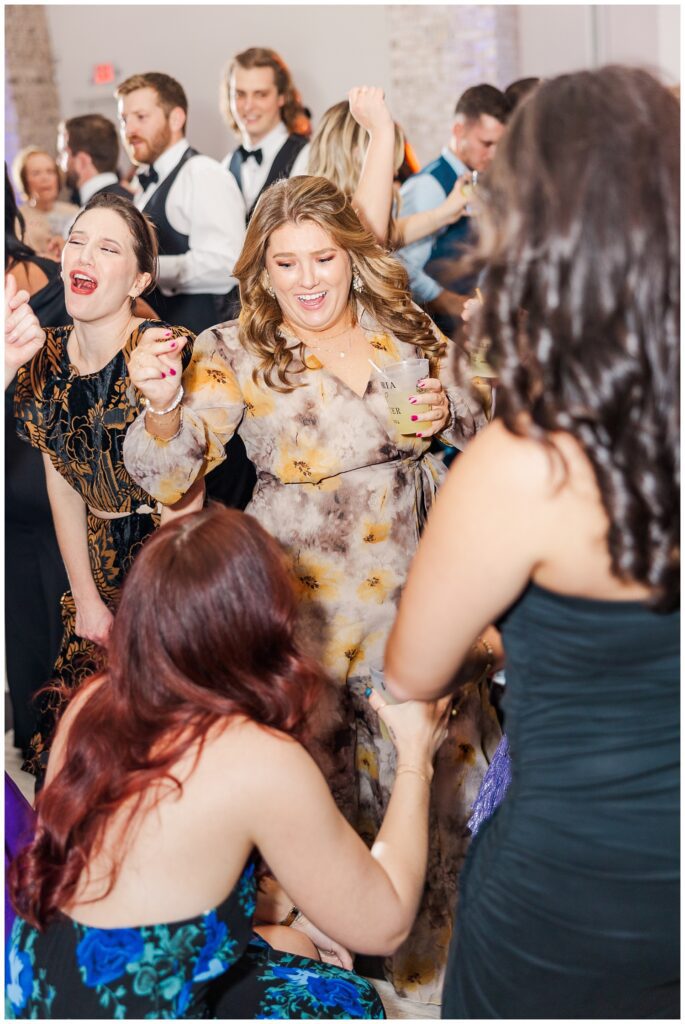 guests at the wedding reception dancing and holding drinks in Wilmington
