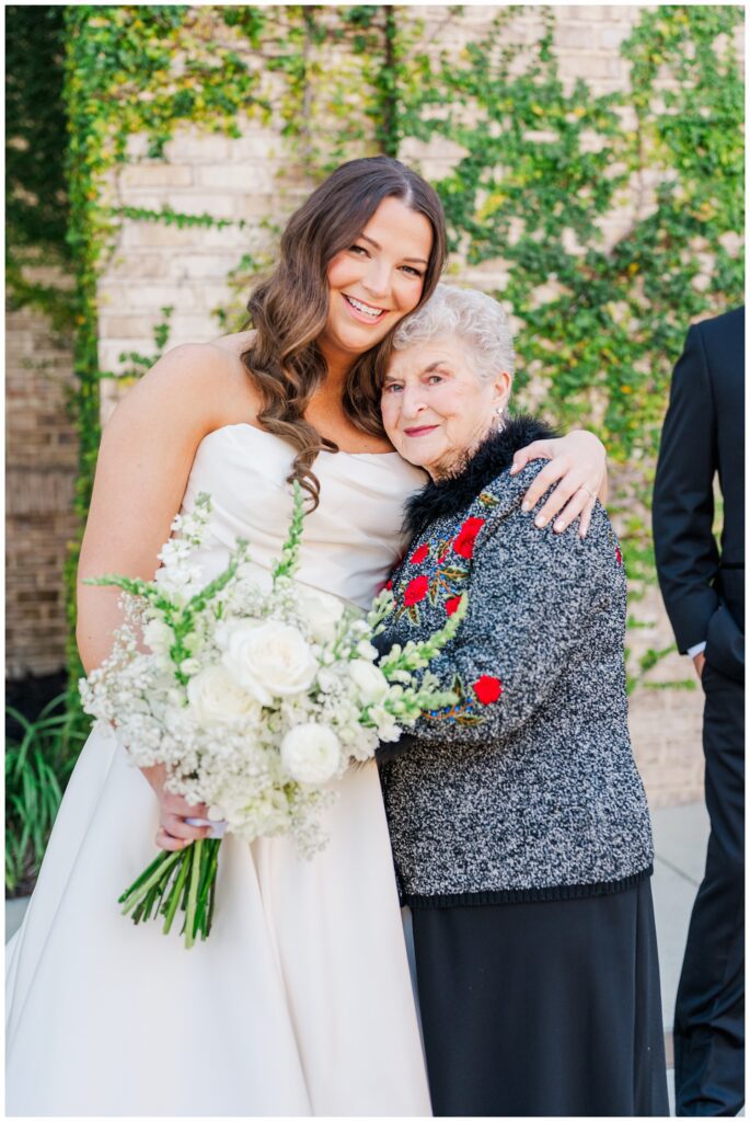bride hugging her grandmother during family portraits at Wrightsville Manor