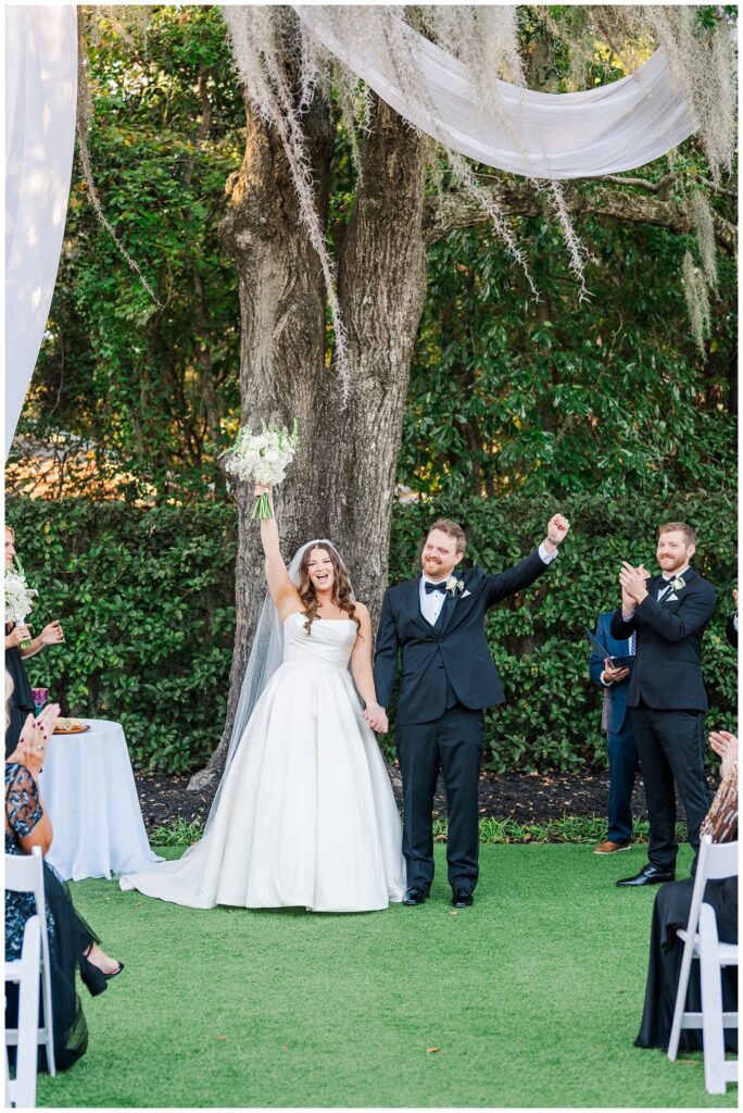 wedding couple cheering for themselves after the wedding ceremony in Wilmington