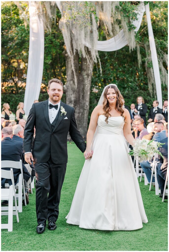 bride and groom walking back down the aisle towards the Wilmington wedding photographer 