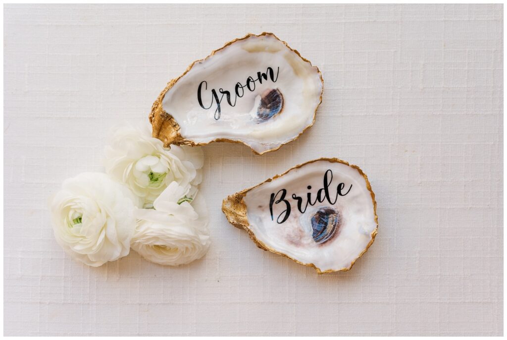 personalized groom and bride oyster shells with white roses on white mat