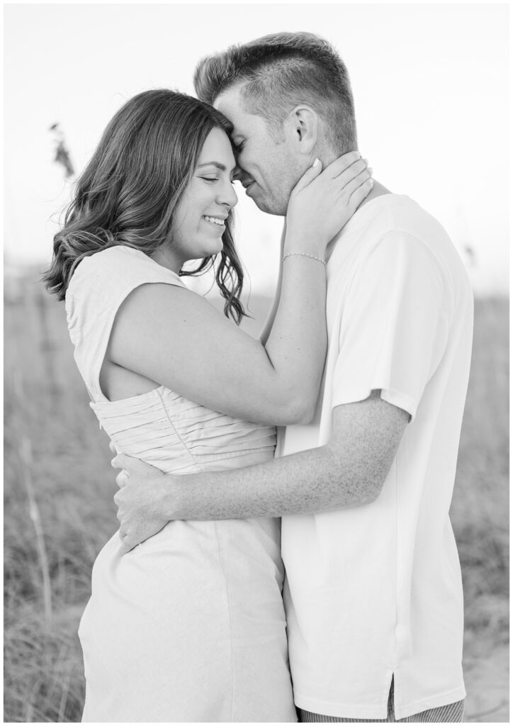 engagement couple hugging on the beach during Wilmington golden hour session