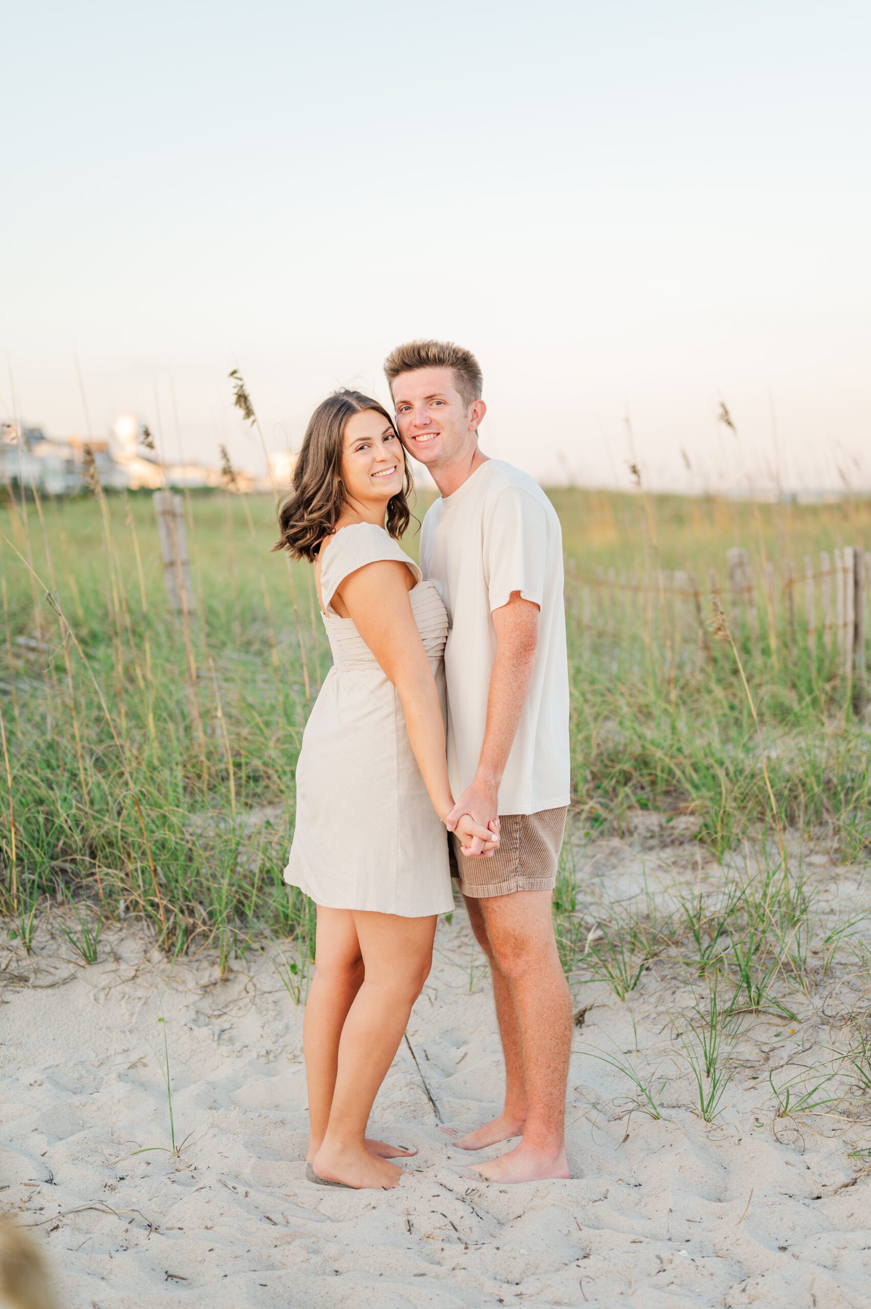 couple holding hands and posing on the beach in Wilmington