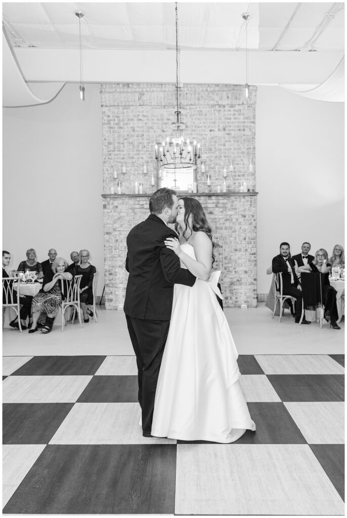 bride and groom share a kiss after their first dance at Wrightsville Manor venue