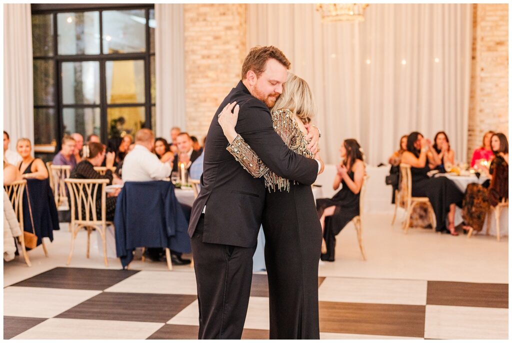 groom hugging his mom after their dance at Wilmington wedding reception venue