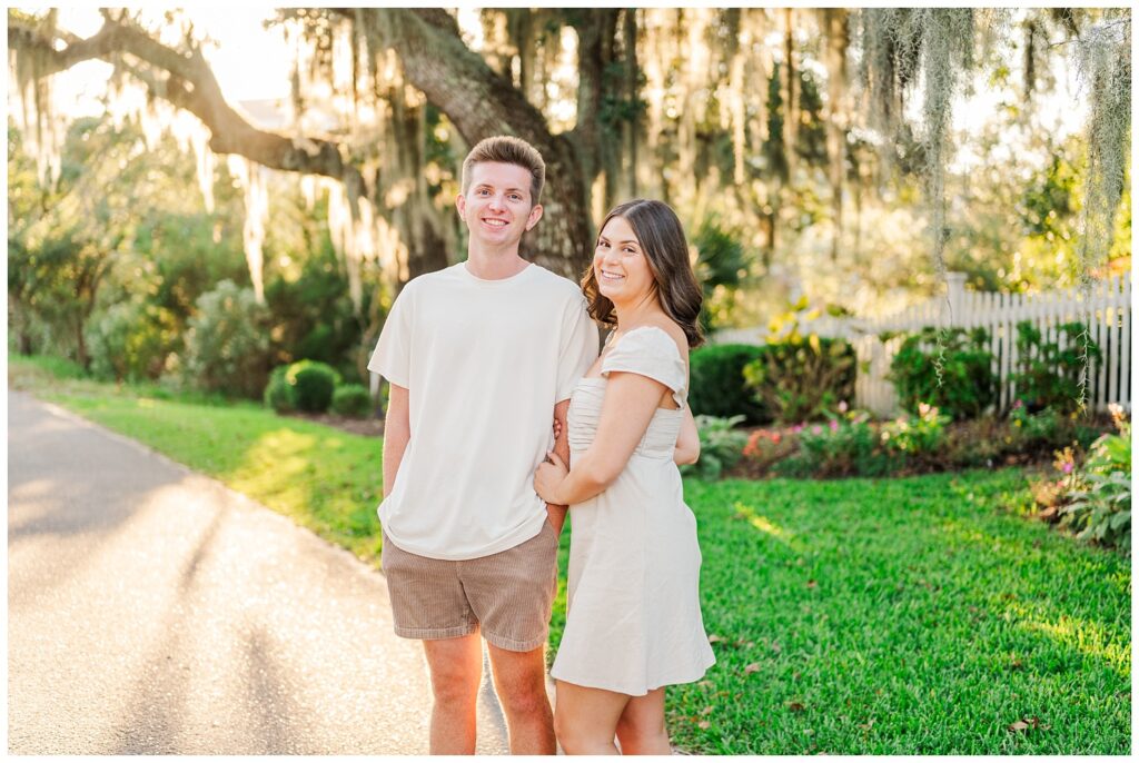 engagement couple holding arms on a road in Wilmington 